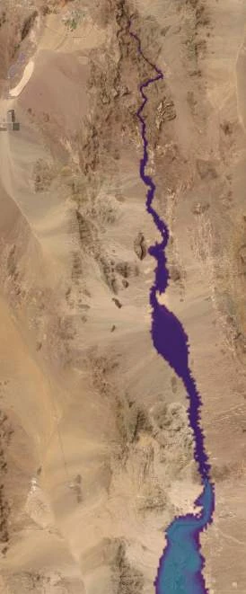 The same view one stage higher: the thread has thickened and the mid-canyon pool has grown