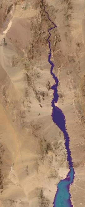 The same view higher again: water now fills more of the canyon floor and begins reaching into side pockets